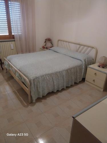 a bedroom with a bed and a tiled floor at Colazione coccolosa in Melfa