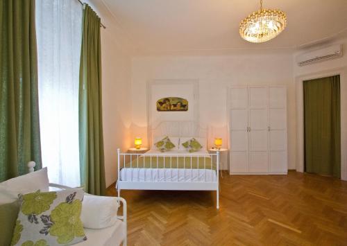 a bedroom with a crib in a room with green curtains at Golden Rooms Bed & Breakfast in Trieste
