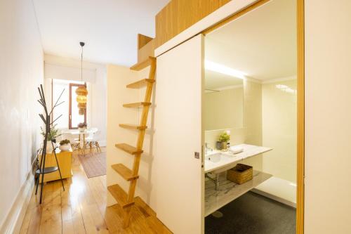 a bathroom with a sink and a mirror at Porto Ribeira Flat in Porto