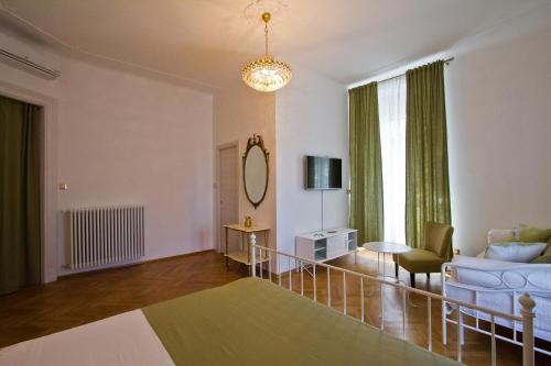 a living room with a bed and a couch at Golden Rooms Bed & Breakfast in Trieste