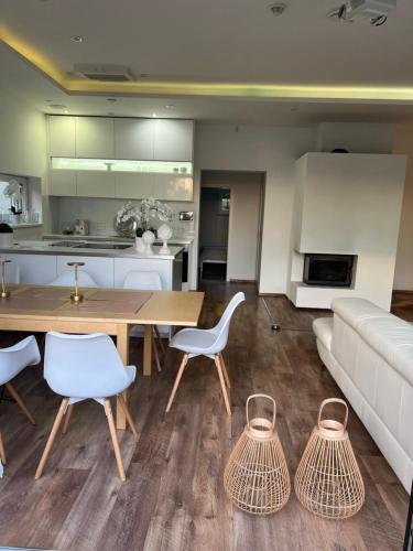 a living room with a couch and a table and chairs at Vila Martina in Popůvky