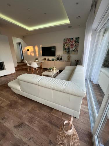 a large white couch in a living room at Vila Martina in Popůvky