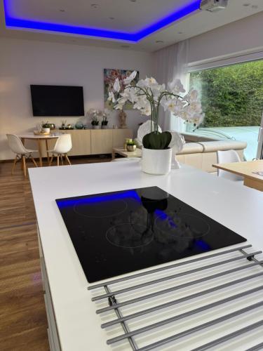 a kitchen with a white island with a blue ceiling at Vila Martina in Popůvky