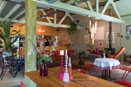 a restaurant with a wooden table with flowers on it at Fort Vuren in Vuren
