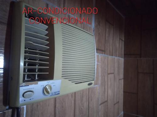 an air conditioner in a room next to a wall at Suíte Love in Paty do Alferes