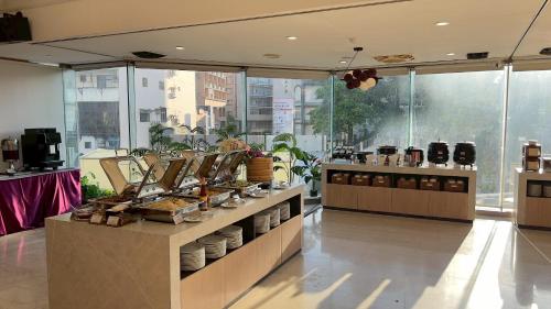 a restaurant with a counter with plates and dishes at T Hotel in Taichung