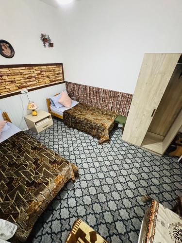 a room with two beds and a door in it at Lovely Goris in Goris