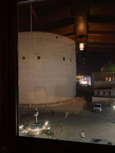 a view from a window of a building with a fountain at Durrat Nizwa Inn in Nizwa