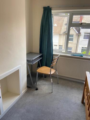 a chair in a room with a desk and a window at Double room to rent near Royal Berkshire Hospital and University of Reading in Reading
