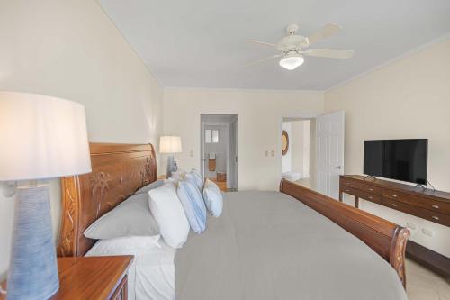 a bedroom with a large bed and a television at Del Mar 5F 3 bdr Garden View in Los Suenos in Herradura