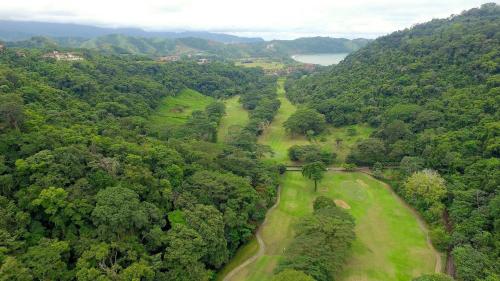 an overhead view of a golf course in a forest at Del Mar 5F 3 bdr Garden View in Los Suenos in Herradura