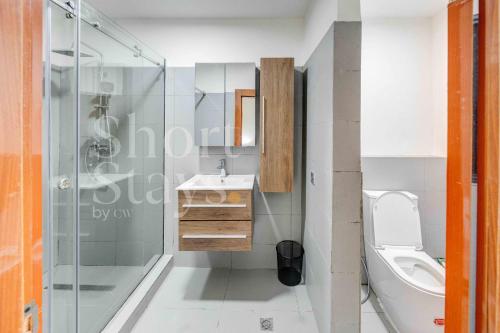 Un baño con inodoro, lavabo y ducha. en Luxury 2-Bedroom Apartment with Pool & Garden View, Lekki Lakowe Lakes Estate, en Lakowe