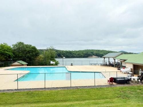 a swimming pool with a view of the water at Stylish Lake Getaway: Kayaks •Foosball •Ping Pong in Badin