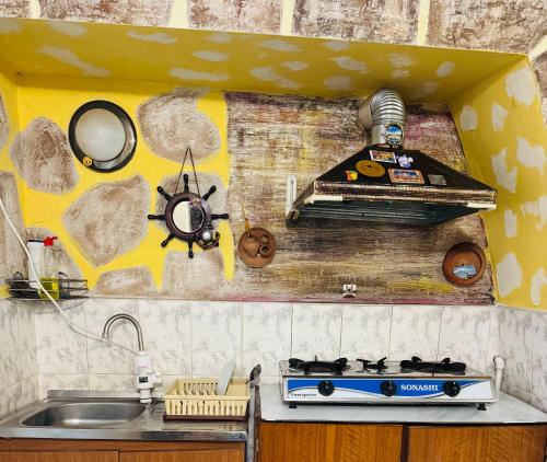 a kitchen counter with a stove and a sink at Lovely Goris in Goris