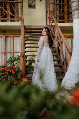 a woman in a wedding dress standing on a staircase at Waikiki beach Hotel Boutique in Dibulla
