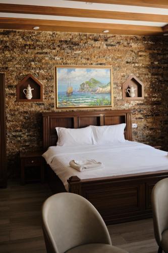 a bed in a room with a brick wall at Durrat Nizwa Inn in Nizwa