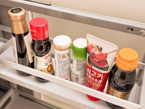 a shelf in a refrigerator filled with condiments at Achasan Mountain's Green Forest Han River View a classic 3-room gallery house full of emotions in Seoul