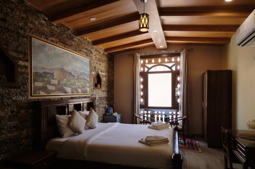 a bedroom with a large bed in a room at Durrat Nizwa Inn in Nizwa