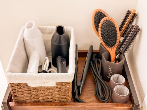 a basket with hair brushes and other items on a shelf at Achasan Mountain's Green Forest Han River View a classic 3-room gallery house full of emotions in Seoul