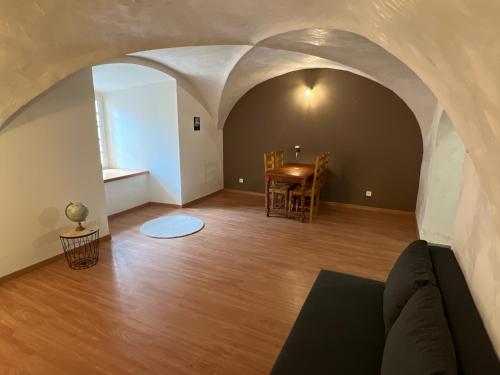 a living room with a couch and a table at Spacious and cozy apartment in Briançon