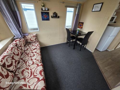 a living room with a bed and a table at CaSa VistA - Holiday Home On The Beach in Clacton-on-Sea