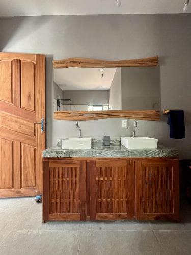 a kitchen with two sinks and a counter top at Barra Beach House in Fortim