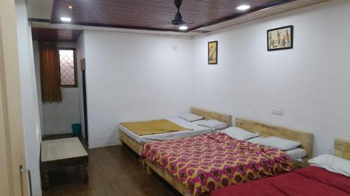 a room with two beds in a room at Kathiyawadi Resort park view matheran in Matheran