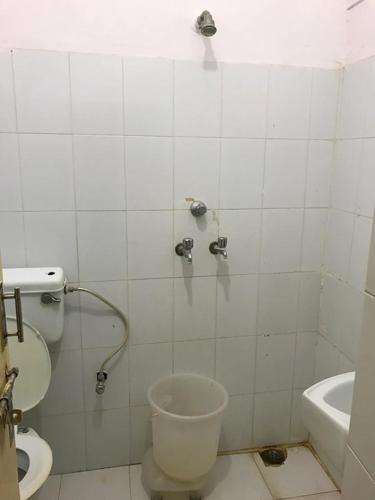 a bathroom with a toilet and a sink at Jaisalmer Safari Base & Camp in Khuri
