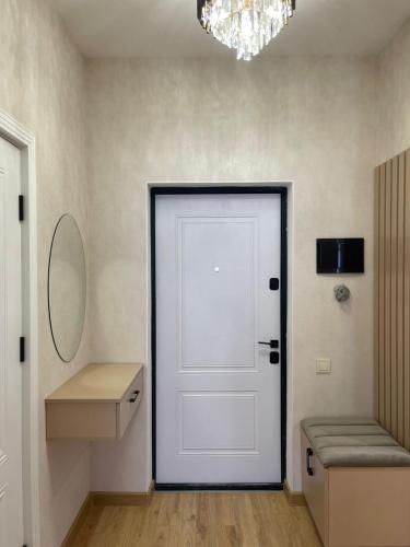 a white door in a room with a mirror at Family friendly in Baku