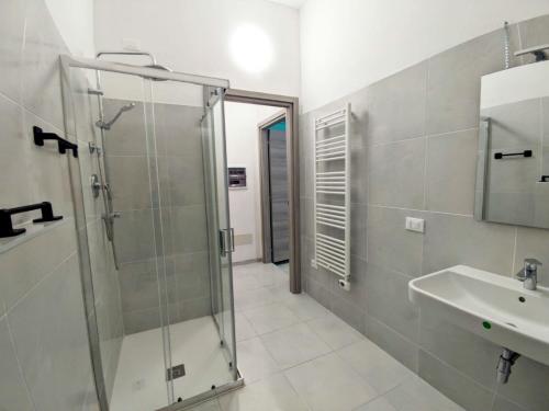 a bathroom with a glass shower and a sink at BookingPeschiera bei Gardaland in Peschiera del Garda