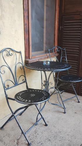 twee stoelen en een tafel voor een raam bij La corte del meleto - appartamento in stile Valdostano in Saint-Pierre