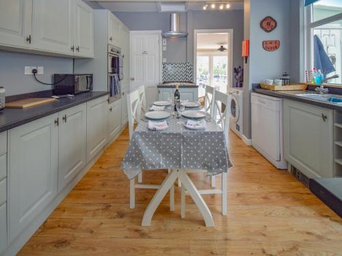 a kitchen with a table and chairs in it at Station House in St Bees