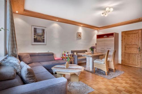 a living room with a couch and a table at Huisnhof in Arrach