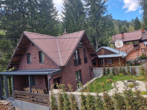 an image of a house with a metal roof at Where Luxury meets Nature !!! in Peje