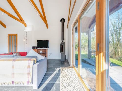 a bedroom with a bed and a sliding glass door at Pyllaubach in Llandeilo