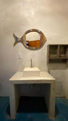 a bathroom with a sink and a mirror on the wall at La Moni- Casa frente ao Mar-Sea View in Prea