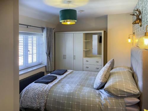 a bedroom with a bed with two pillows on it at Lily Pad - Uk49104 in Helmsley