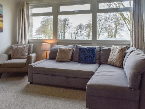 a living room with a couch and a window at Sea La Vie in Bideford