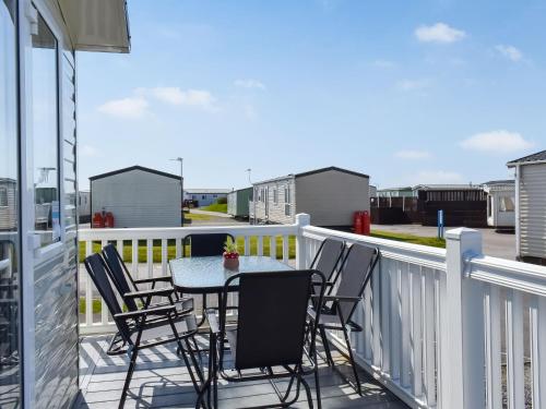 a patio with chairs and a table on a balcony at The Hideaway - Uk49292 in Morecambe