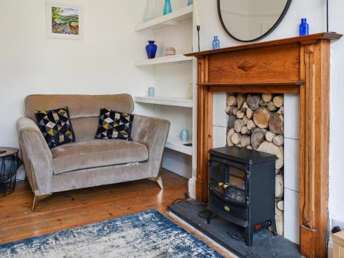 a living room with a chair and a wood stove at 2 Le Dorney Villa - Uk49804 in Par