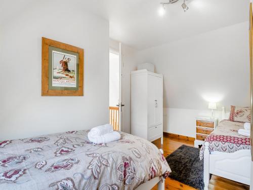 a bedroom with two beds and a dresser at Chestnut Tree Barn in Saint Lawrence