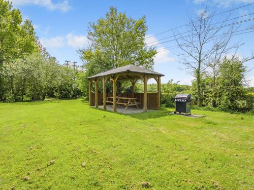 a gazebo in a field with a trash can at Chestnut Tree Barn in Saint Lawrence