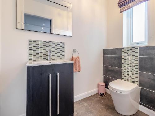 a bathroom with a sink and a toilet at The Old School House in Barnsley