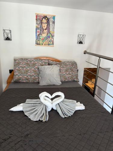 a bed with two white towels on it at Banija studio apartments in Karlovac