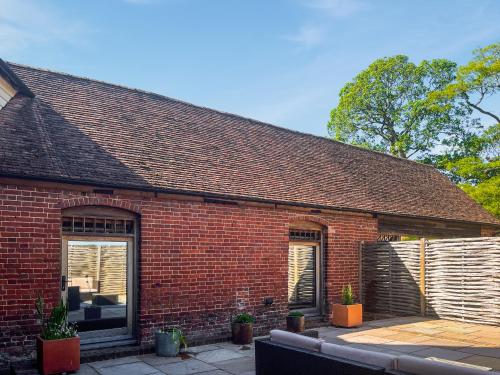 a red brick building with two windows and a fence at The Oast - Uk49207 in Lenham