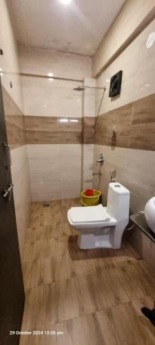 a bathroom with a white toilet in a room at baga beach see side in Samuāpur