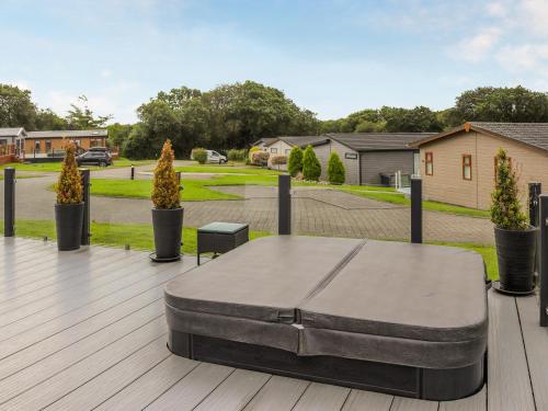 a bed sitting on top of a wooden deck at Seagrass Lodge in Carnguwch