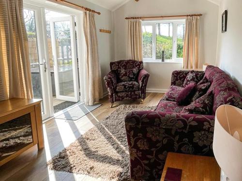 a living room with a couch and a chair at Bluebell Apartment - Uk49298 in Woolfardisworthy
