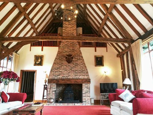 a living room with a brick fireplace in a house at Doves Barn in Needham Market