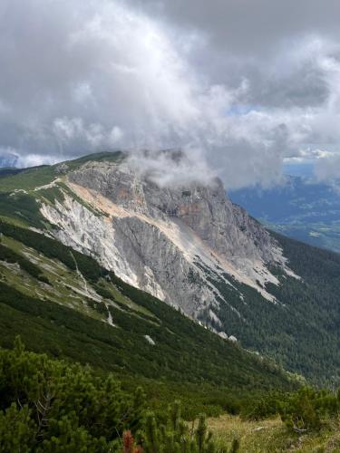 a mountain with clouds on top of it at RaxChalet in Prein